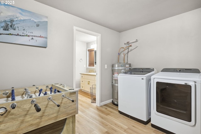 23595 E Lolo Pass Rd, Rhododendron, OR 97049 - laundry area featuring water heater, separate washer and dryer, light wood-type flooring, and baseboards