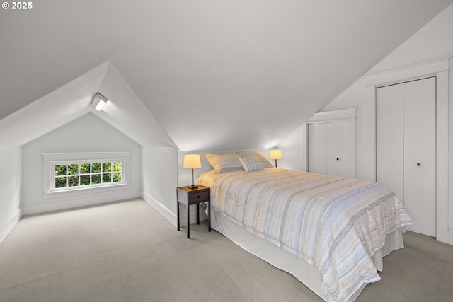 bedroom featuring vaulted ceiling, carpet, baseboards, and a closet
