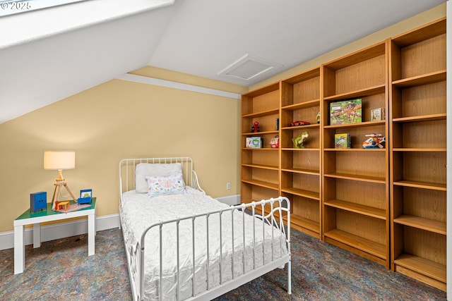 carpeted bedroom with attic access, baseboards, and vaulted ceiling