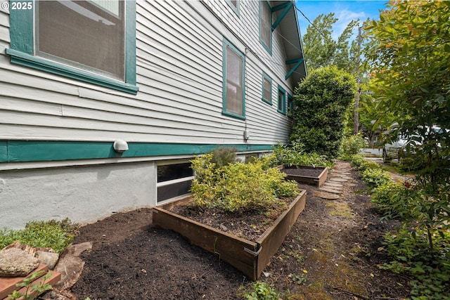 view of side of home featuring a vegetable garden