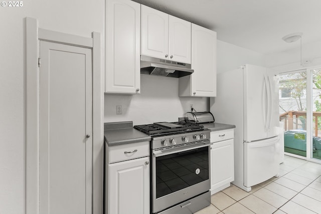 339 W Laurelwood Ct, Roseburg, OR 97470 - kitchen with stainless steel range with gas cooktop, under cabinet range hood, freestanding refrigerator, white cabinets, and light tile patterned floors