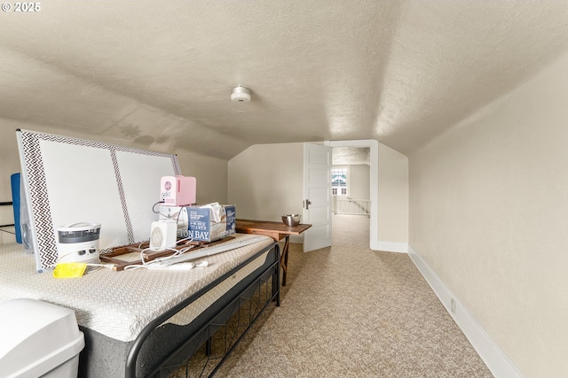 339 W Laurelwood Ct, Roseburg, OR 97470 - carpeted bedroom with a textured ceiling, vaulted ceiling, and baseboards
