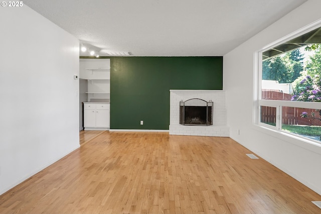 1437 Sequoia Ave, Springfield, OR 97477 - unfurnished living room with light wood finished floors and a brick fireplace