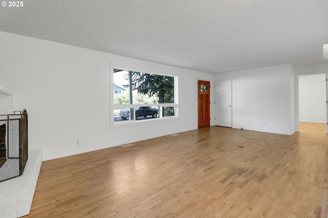 1437 Sequoia Ave, Springfield, OR 97477 - unfurnished living room featuring light wood-type flooring and a textured ceiling