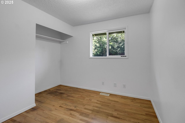 1437 Sequoia Ave, Springfield, OR 97477 - unfurnished room with wood finished floors, a textured ceiling, and baseboards