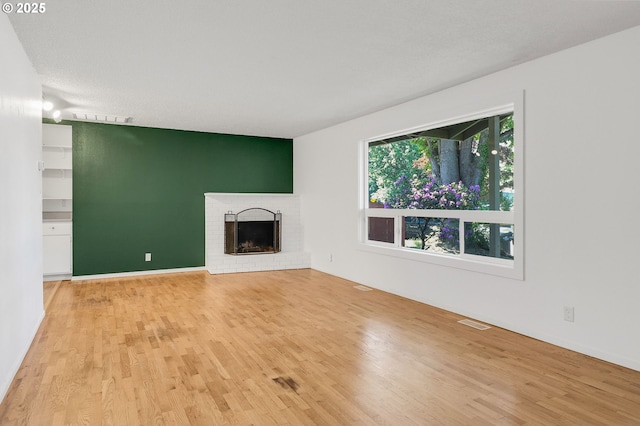 1437 Sequoia Ave, Springfield, OR 97477 - unfurnished living room featuring light wood-style floors and a brick fireplace