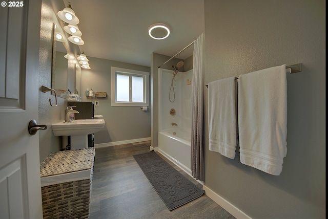 92700 Holly Ln, Astoria, OR 97103 - full bathroom featuring wood finished floors, baseboards, and bathing tub / shower combination