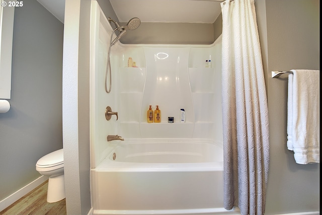 92700 Holly Ln, Astoria, OR 97103 - full bathroom featuring toilet, wood finished floors, shower / bath combo, and baseboards