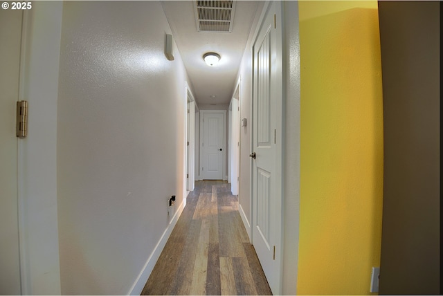 92700 Holly Ln, Astoria, OR 97103 - hallway featuring dark wood-type flooring, baseboards, and a textured wall