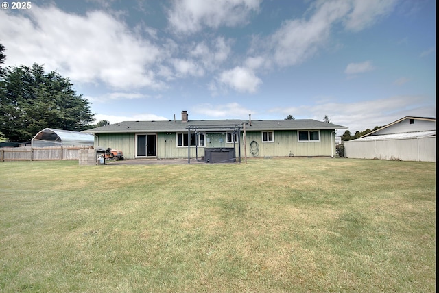 92700 Holly Ln, Astoria, OR 97103 - rear view of house featuring a hot tub, a patio area, a chimney, and board and batten siding