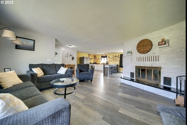 92700 Holly Ln, Astoria, OR 97103 - living room with wood finished floors and a fireplace