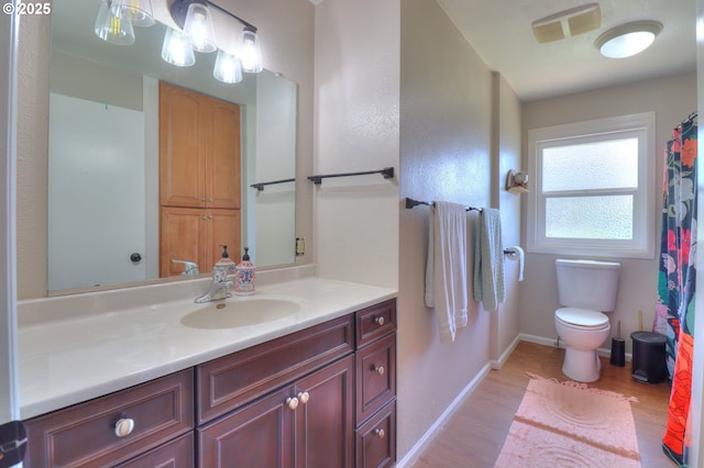 94178 9th St, Gold Beach, OR 97444 - bathroom with wood finished floors, vanity, toilet, and baseboards