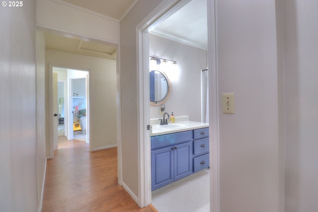 94178 9th St, Gold Beach, OR 97444 - bathroom with wood finished floors, vanity, baseboards, and ornamental molding