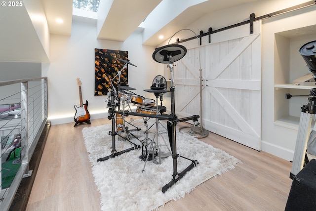60486 Seventh Mountain Dr, Bend, OR 97702 - office featuring baseboards, a barn door, and wood finished floors