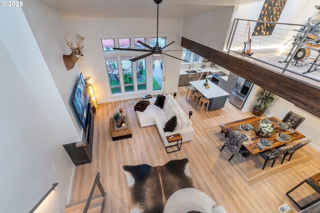 60486 Seventh Mountain Dr, Bend, OR 97702 - living room featuring a ceiling fan, a towering ceiling, and wood finished floors
