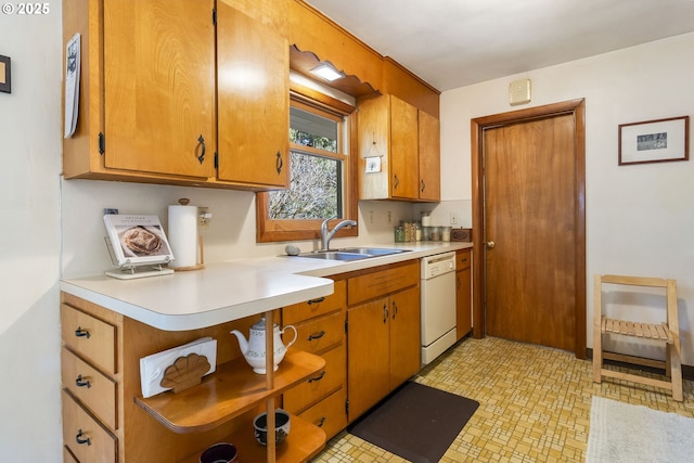 kitchen with a sink, dishwasher, brown cabinetry, and light countertops