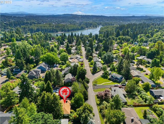 bird's eye view featuring a residential view, a forest view, and a water and mountain view