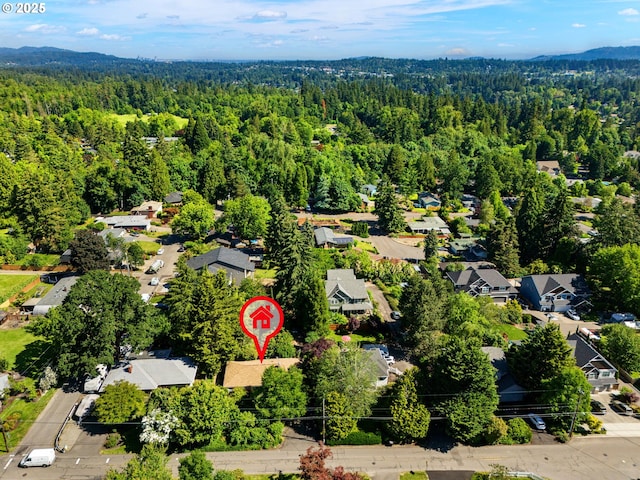 drone / aerial view featuring a residential view and a view of trees