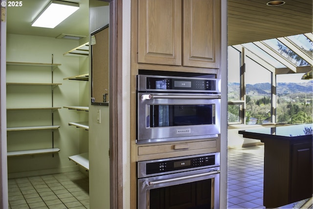 395 Rio Nes Ln, Roseburg, OR 97470 - kitchen featuring oven, light tile patterned floors, and a mountain view