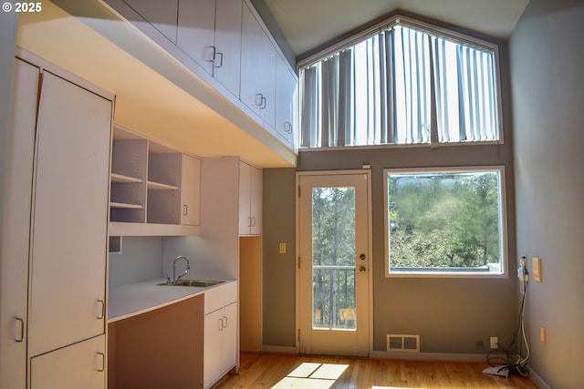 395 Rio Nes Ln, Roseburg, OR 97470 - kitchen with light wood finished floors, light countertops, white cabinets, and open shelves