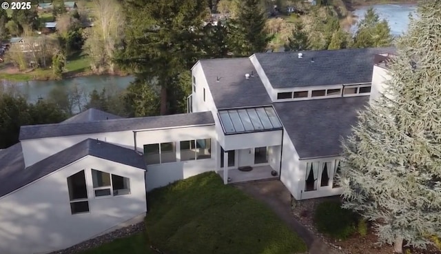 395 Rio Nes Ln, Roseburg, OR 97470 - rear view of property featuring a patio, stucco siding, a water view, and a standing seam roof