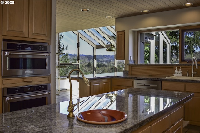 395 Rio Nes Ln, Roseburg, OR 97470 - kitchen featuring a mountain view, double wall oven, dark stone counters, recessed lighting, and dishwasher