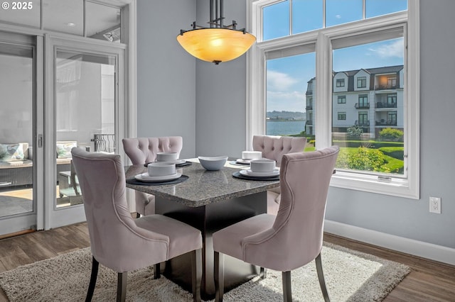707 N Hayden Island Dr Unit 217, Portland, OR 97217 - dining area featuring wood finished floors and a water view