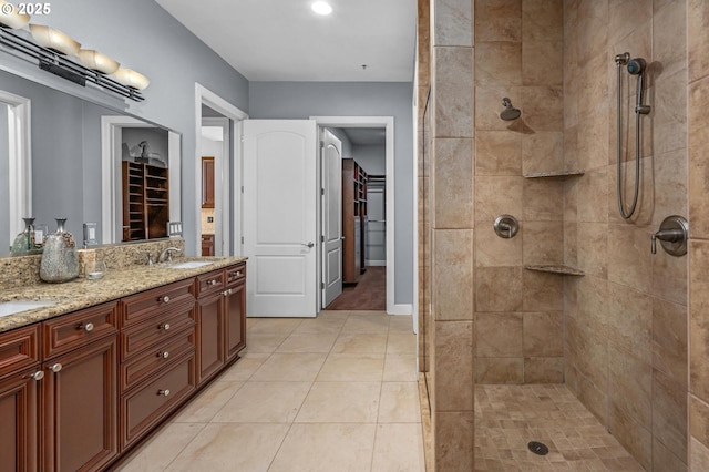 707 N Hayden Island Dr Unit 217, Portland, OR 97217 - bathroom with a tile shower, double vanity, tile patterned flooring, and recessed lighting