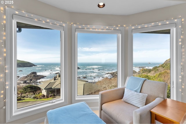 sitting room with a beach view and a water view