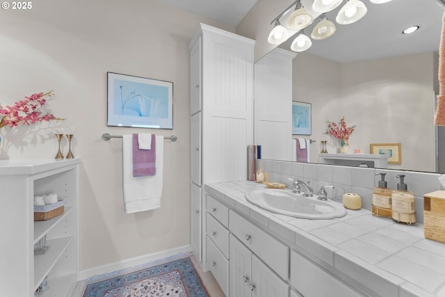 bathroom with vanity and baseboards