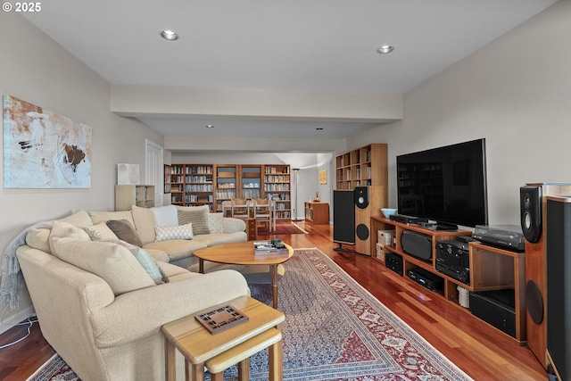 living room featuring wood finished floors, beam ceiling, and recessed lighting