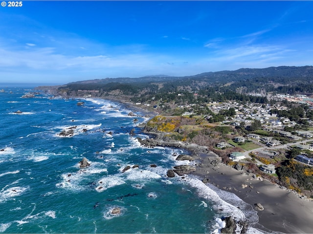 drone / aerial view featuring a water and mountain view