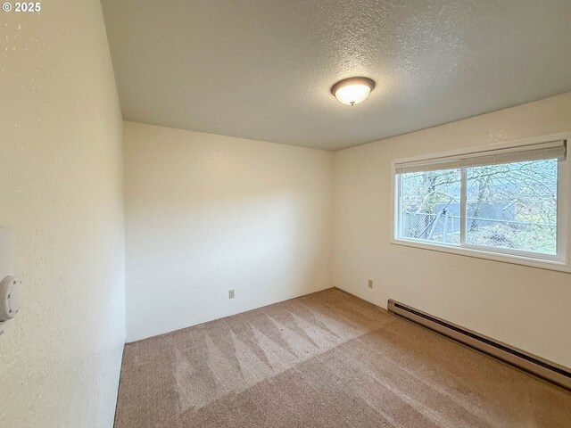 1883 Green Ave, Roseburg, OR 97471 - empty room with a baseboard radiator, a textured ceiling, and carpet floors