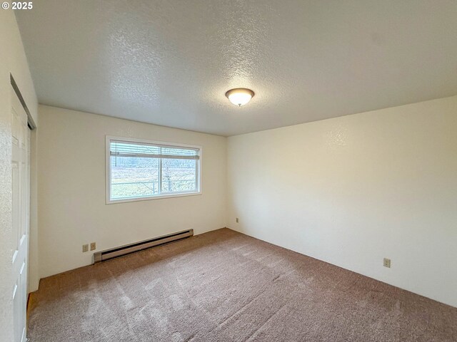 1883 Green Ave, Roseburg, OR 97471 - carpeted spare room with baseboard heating and a textured ceiling