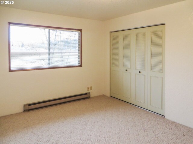 1883 Green Ave, Roseburg, OR 97471 - unfurnished bedroom with baseboard heating, carpet flooring, multiple windows, and a closet