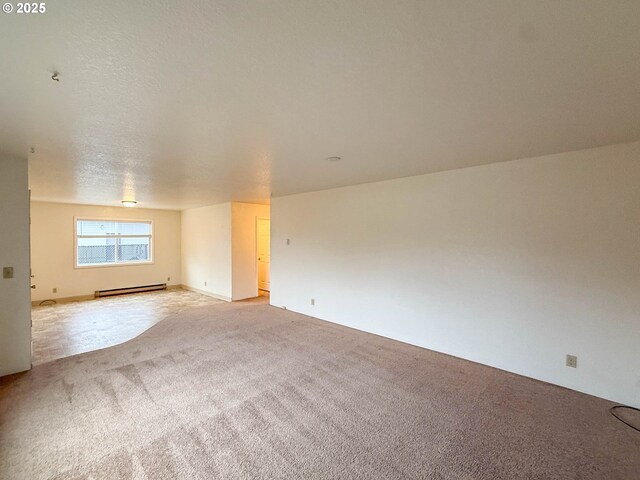 1883 Green Ave, Roseburg, OR 97471 - unfurnished room featuring a baseboard heating unit and light colored carpet