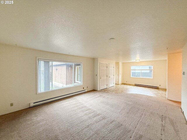 1883 Green Ave, Roseburg, OR 97471 - spare room featuring a baseboard radiator, a baseboard heating unit, carpet floors, and a textured ceiling