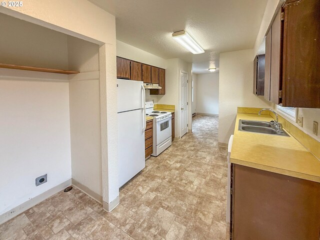 1883 Green Ave, Roseburg, OR 97471 - kitchen featuring white appliances, a sink, baseboards, and light countertops