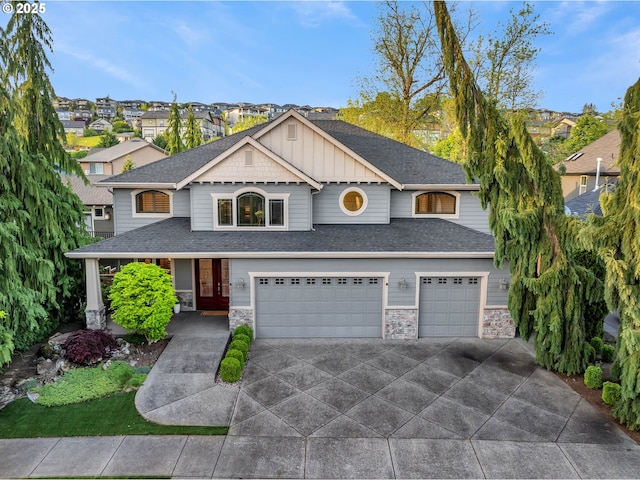 669 W T St, Washougal, WA 98671 - craftsman-style house featuring an attached garage, driveway, a shingled roof, and stone siding