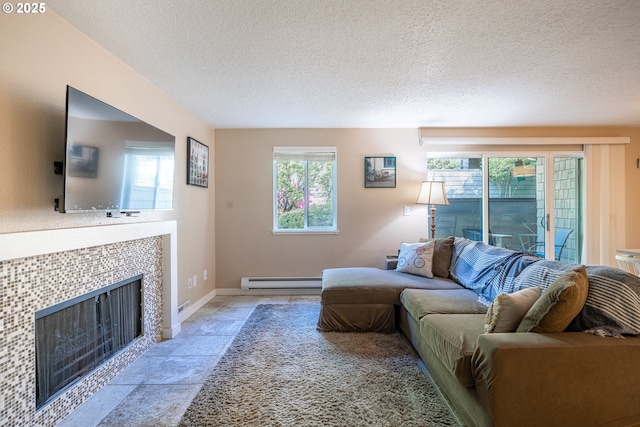 living area with baseboards, a baseboard radiator, a textured ceiling, and a tile fireplace