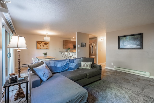 living area featuring a textured ceiling, a baseboard heating unit, baseboards, and a baseboard radiator