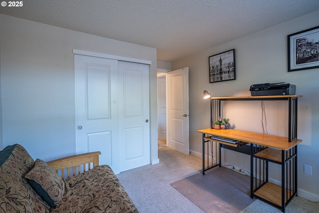 carpeted bedroom with a closet, a textured ceiling, and baseboards