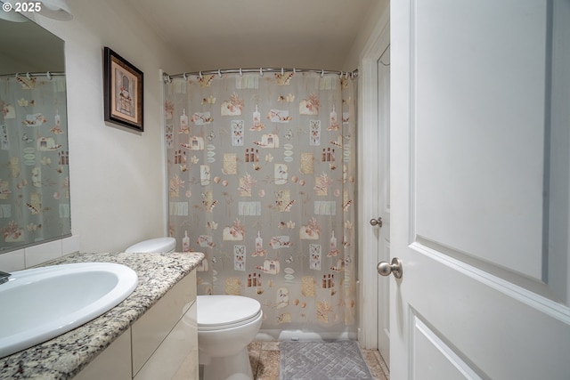 bathroom with vanity, tile patterned floors, a shower with curtain, and toilet