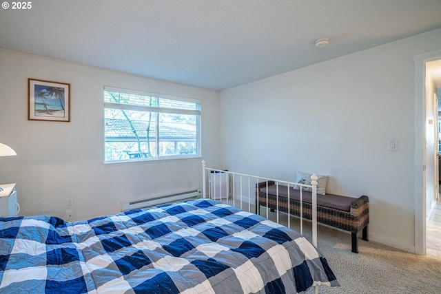 carpeted bedroom with a baseboard heating unit