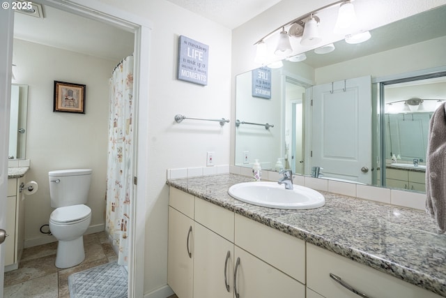 full bathroom with toilet, baseboards, and vanity