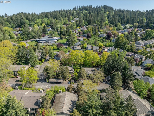 drone / aerial view with a residential view and a wooded view