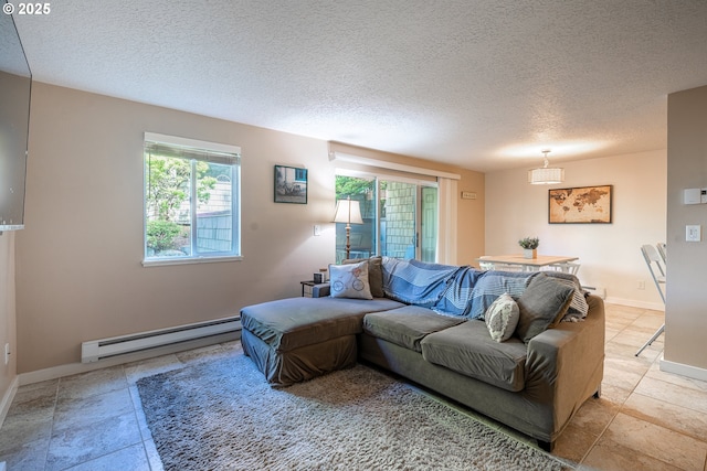 living area with baseboards, a textured ceiling, and a baseboard heating unit