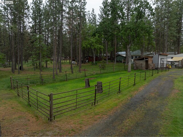 view of dirt / gravel driveway with an exterior structure