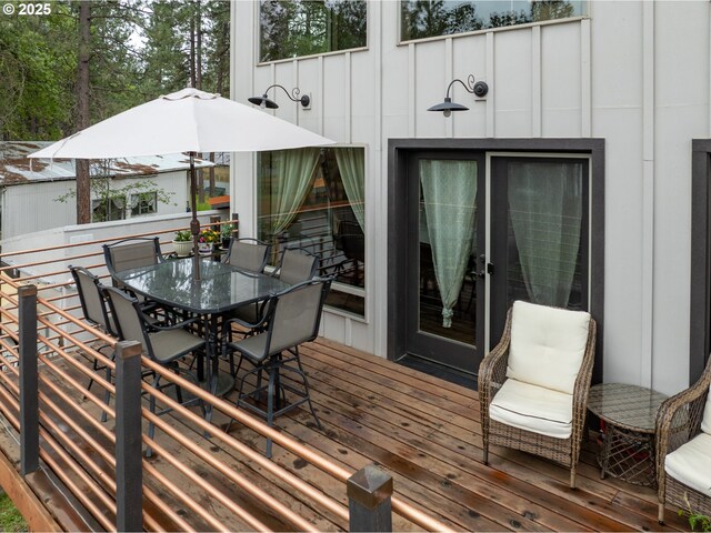 wooden terrace with outdoor dining space