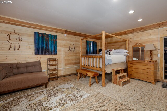 bedroom with wood walls and recessed lighting